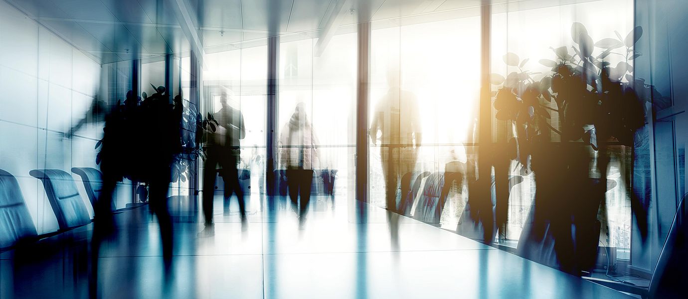 Conference table and chairs with blurred businesspeople